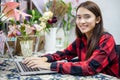 Asian women florists using notebook for working and smiling in flower shop