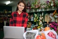 Asian women florists using notebook for working and smiling in flower shop Royalty Free Stock Photo