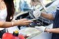 Asian women get contact numbers from auto mechanics after fixing the car engine problem and QR code scan to pay for gas after