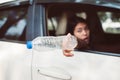 Asian woman hand holding plastic bottle on the road,Environmental protection global warming concept,Close up Royalty Free Stock Photo