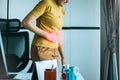 Asian women having painful stomach ache during working at home,Female suffering from abdominal pain,Period cramps,Hands squeezing Royalty Free Stock Photo