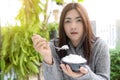 Asian women holding cooked jasmine rice bowls with spoon. Wearing a gray sweater. Delicious breakfast in the morning Royalty Free Stock Photo