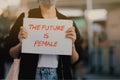 Asian women holding The future is Female text on paper,feminisms movement Royalty Free Stock Photo