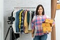 Asian women holding laptop computer with carry brown parcel or cardboard boxes Royalty Free Stock Photo