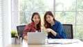 Asian women at home office, Happy two young asian women working with laptop computer at office, Asian friends working together Royalty Free Stock Photo