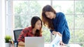 Asian women at home office, Happy two young asian women working with laptop computer at office, Asian friends working together Royalty Free Stock Photo
