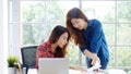 Asian women at home office, Happy two young asian women working with laptop computer at office, Asian friends working together Royalty Free Stock Photo