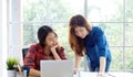 Asian women at home office, Happy two young asian women working with laptop computer at office, Asian friends working together Royalty Free Stock Photo