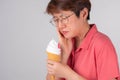 Asian women with intense toothache pain after  biting ice cream, on white background Royalty Free Stock Photo