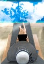 Asian Women lifestyle play laptop and relaxing near luxury swimming pool sunbath, summer day at the beach resort in the hotel. Royalty Free Stock Photo