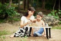 Asian women with little child playing on nature Royalty Free Stock Photo
