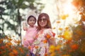 Asian woman and little girl happiness emotion in yellow cosmos flower blooming field Royalty Free Stock Photo