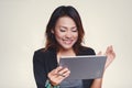 Asian women look at his iPad with a happy mood Royalty Free Stock Photo