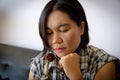 Asian women looking at dried roses, thoughts of past love or Valentine`s Day