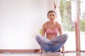 Asian women meditation and stretching relax their muscles by doing yoga in the room