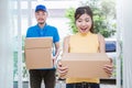 Asian woman and asian man carry boxes