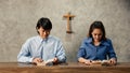 Asian Women and men, The faithful and Christian are reading the Bible to pray to Jesus in the crucified church. Concept believe