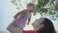 Asian woman mother playing with happy baby infant in garden on sunny day under tree on picnic vacation. smile baby happy fun Royalty Free Stock Photo