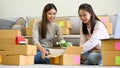 Asian women packing their stuff into a cardboard box, preparing stuff to relocated