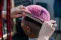 Asian woman with pink hair getting a haircut in a barbershop. Royalty Free Stock Photo