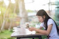 Asian women playing mobile phones and drinking iced tea Royalty Free Stock Photo