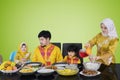 Asian woman pouring syrup for her family