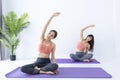 Asian woman practicing yoga indoor with easy and simple position to control breathing in and out in stretching arm posture