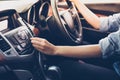 Asian Women press button on car radio for listening to music. Royalty Free Stock Photo