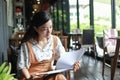 Asian women reading book and smiling and happy Relaxing in a coffee shop Royalty Free Stock Photo