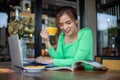 Asian women reading book and smiling and happy Relaxing in a coffee shop after working in a successful Royalty Free Stock Photo