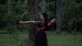 Asian Women ready to shoot an arrow from the bow while standing bravely