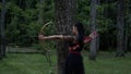 Asian Women ready to shoot an arrow from the bow while standing bravely