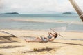 Asian women relaxing in hammock summer holiday on beach Royalty Free Stock Photo