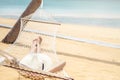 Asian women relaxing in hammock summer holiday on beach Royalty Free Stock Photo