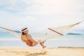 Asian women relaxing in hammock summer holiday on beach Royalty Free Stock Photo