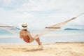 Asian women relaxing in hammock summer holiday on beach Royalty Free Stock Photo