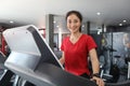 Asian women running sport shoes at the gym while a young caucasian woman is having jogging on the treadmill Royalty Free Stock Photo