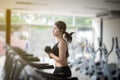 Asian women running sport shoes at the gym while a young caucasian woman is having jogging on the treadmill Royalty Free Stock Photo
