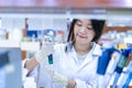 Asian women scientist with making research in clinical laboratory