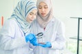 Asian women scientist with test tube making research in clinical laboratory.Science Oil pouring, Formulating the chemical for