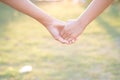 Asian women shaking hands in the warmth of the morning light.