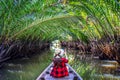 Asian women sitting on a boat at tunnel from nypa fruticans or palm tree in Surat thani,Thailand. Royalty Free Stock Photo