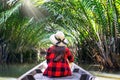 Asian women sitting on a boat at tunnel from nypa fruticans or palm tree in Surat thani,Thailand. Royalty Free Stock Photo