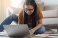 Asian women sitting using laptops at home