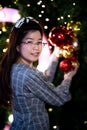 Asian women smile sweetly. Person are celebrating Christmas or New Years concept. Woman touching red ball Christmas.