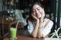 Asian women smiling and happy Relaxing with green tea in a coffee shop Royalty Free Stock Photo