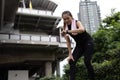 Asian women in sportswear stop and looking to screen of fitness application in smartwatch on wrist to check results after workout