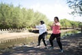 asian women sportswear warming up together