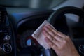 Asian women spry soap and clean car steering wheel with napkin, Concept for Corona virus prevention and disinfectio