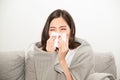 Asian women with stress that suffer from allergies and close the nose with tissue paper. Because of having sneezing all the time.